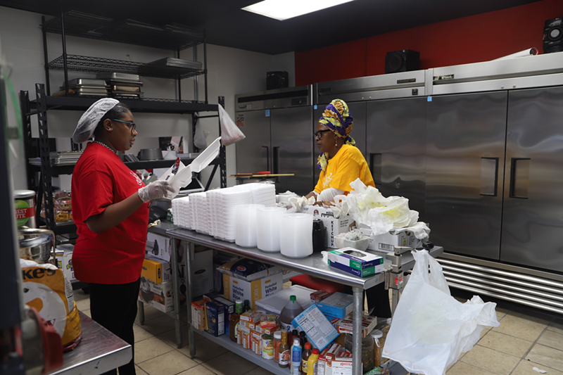 Just Cookin' employees in the kitchen boxing up to-go orders - PHOTO: NICK SWARTSELL