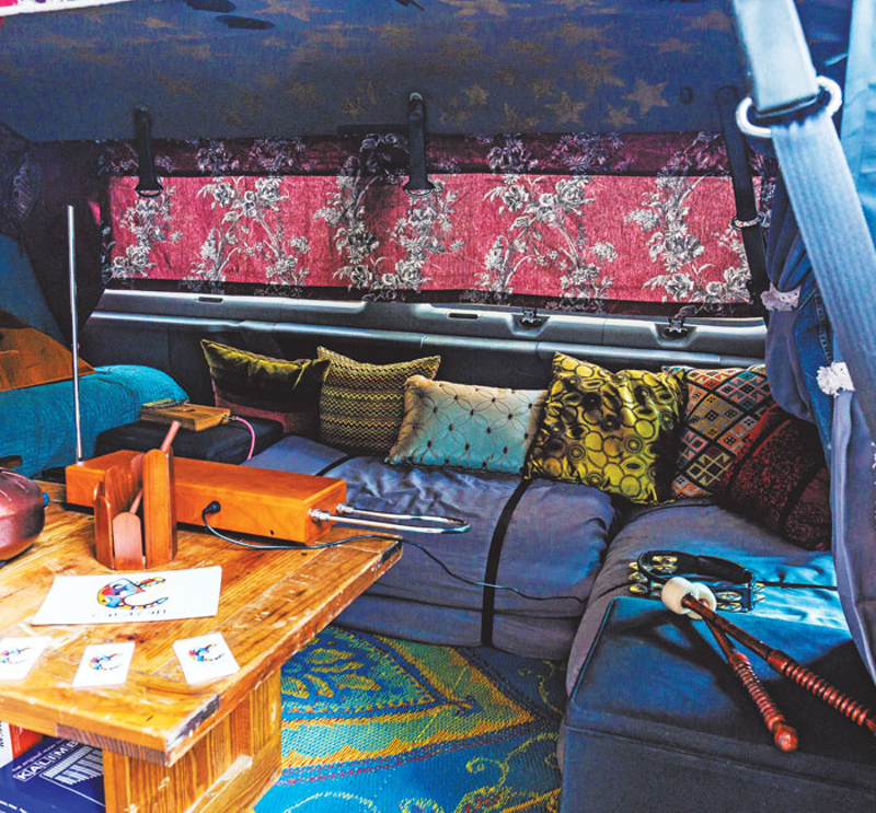 Cozy seating and bohemian accessories inside the van - Photo: Hailey Bollinger