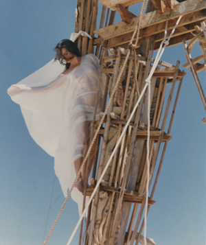Photograph taken by Dale Scott of Crimson Rose climbing the Man, 1991, Collection of Nevada Museum of Art, Center for Art + Environment Archive Collections, Gift of Crimson Rose