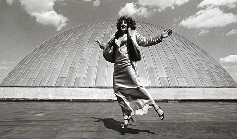 Melvin Grier had always been curious about the space on the roof of Union Terminal, behind the dome. He took a few standing shots oh his model, but then asked her to jump, inspired by the mid-century celebrity portrait photographer Philippe Halsman. // "Clothes Encounter," unknown year. Black and white inkjet print from scanned 35mm negative, 18 x 10 inches. - Courtesy of the artist Melvin Grier