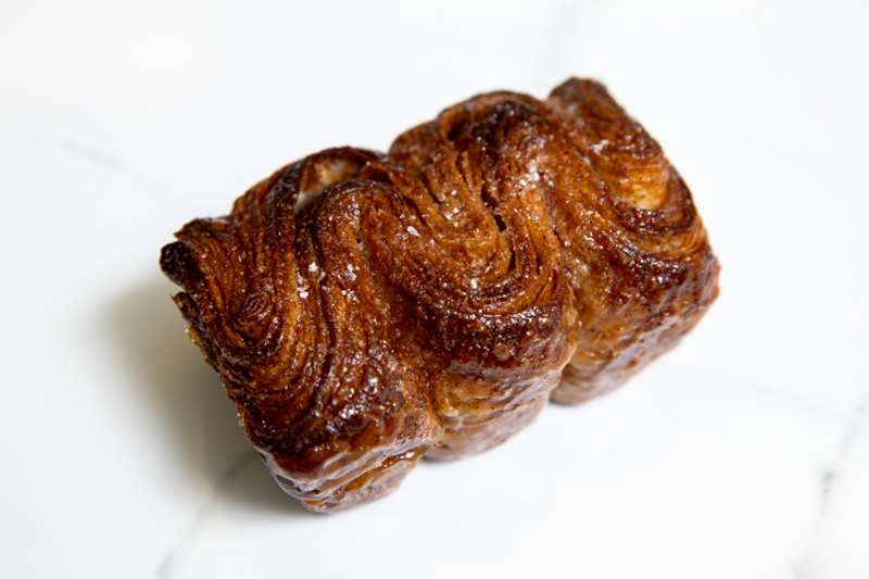 Townsend's ume kouign-amann (oo-may coo-in ah-mahn) is a hybridization of sorts: a French croissant-like pastry glazed with syrup made from salted and pickled Japanese plums - Photo: Hailey Bollinger