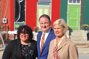 Seven Hills Neighborhood Houses' Tia Brown, FCC's Jeff Berding, and Laura Brunner of the Greater Cincinnati Redevelopment Authority pose for a photo - Nick Swartsell