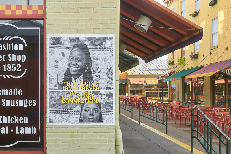 An "On Belonging" portrait installed at Over-the-Rhine's Findlay Market. - Installation photo by Audrey Law//Portraits by Asa Featherstone