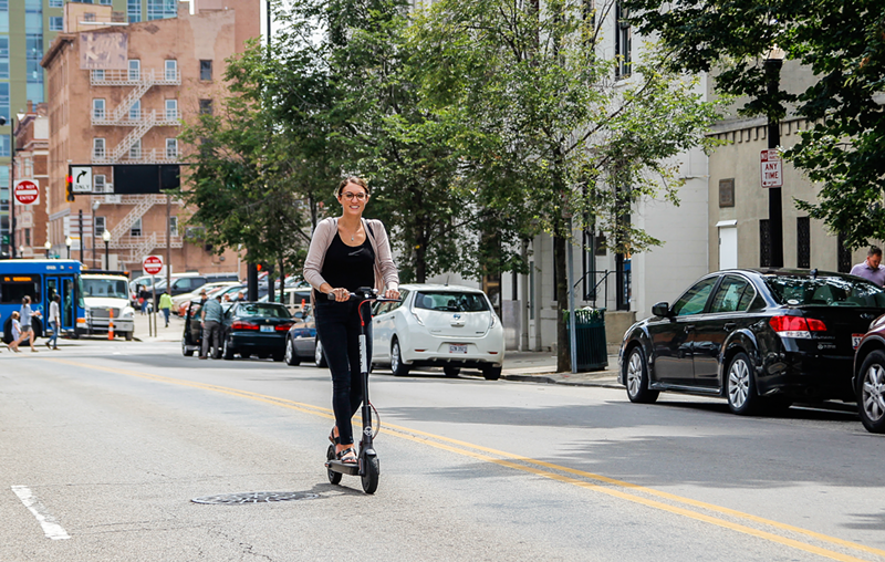 Taylor Speed, our CityBeat designer, testing out a Bird scooter - Photo: Hailey Bollinger