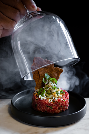 The German-inspired tartare with sauerkraut kimchi, everything seasoning, smoke, and rye crackers - Photo: Wagstaff Chicago