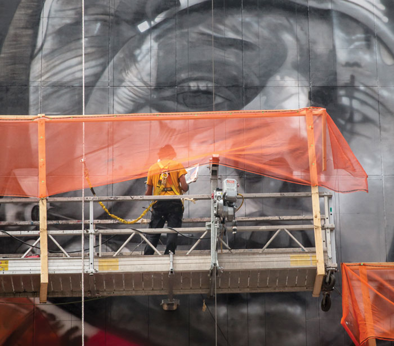 Eduardo Kobra at work on the Armstrong mural - Matt Steffen/ArtWorks