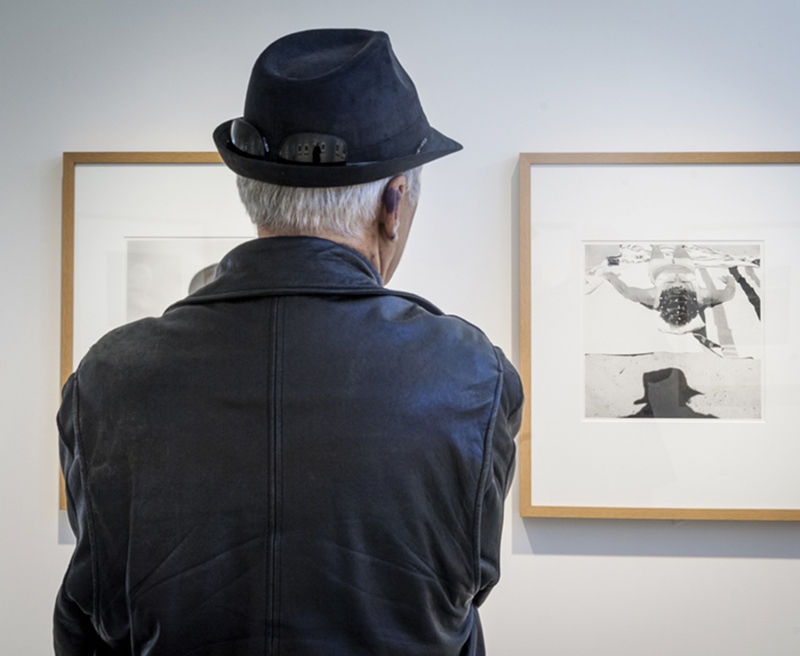 A viewer attending the 2014 FotoFocus-sponsored Vivian Maier exhibit.