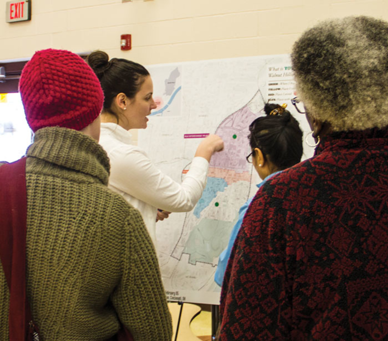 Walnut Hills Redevelopment Foundation staffer Thea Munchel works with attendees on a neighborhood mapping activity at a Feb. 6 planning session.