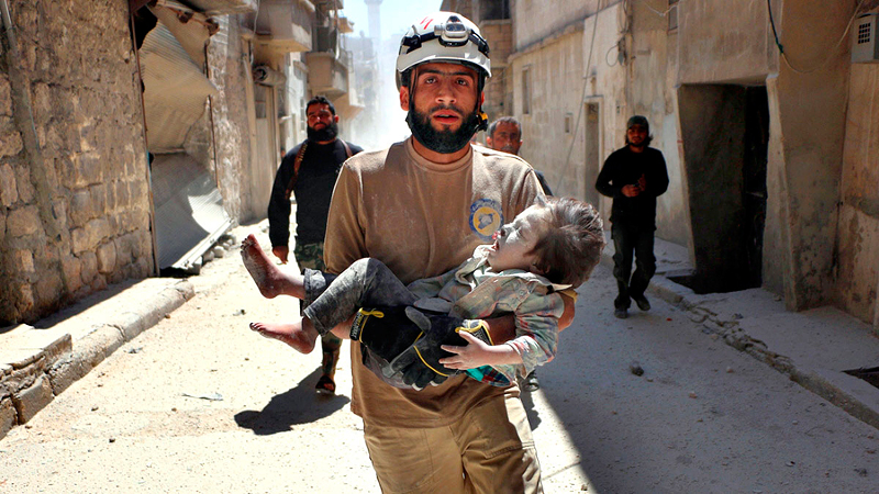 A volunteer rescues a Syrian child in "The White Helmets." - Photo: Orlando von Einsiedel