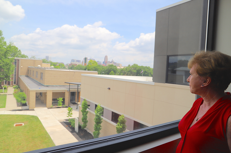 Center for Addiction Treatment CEO Sandra Kuehn looks out over the nonprofit's original facility, where it would like to build more residential treatment space for women. But she has more immediate concerns — CAT could lose funding it receives from the city this year. - Nick Swartsell