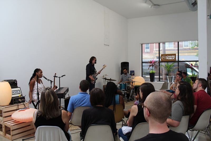 Joy Ike (seated) performs at Chase Public in July. - PHOTO: Marcus Donaldson