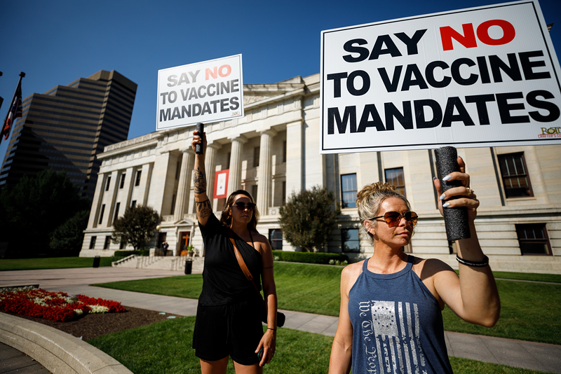 Two women protest vaccine mandates Aug. 24 outside a hearing at the Statehouse on legislation that would outlaw the practice from employers. - Photo: Graham Stokes/Freelance Photographer