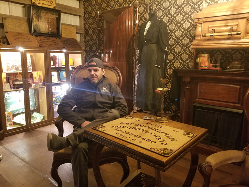 In Terror Town's museum of oddities, owner James Gregory sits in the chair where PINK had previously seen spirits. - Photo: Allison Babka