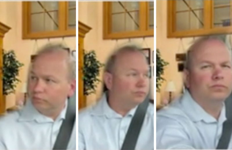 In front of a fake office background, Andrew Brenner wears a seatbelt and looks both ways while driving before turning his camera off. - Image: The Ohio Channel video still
