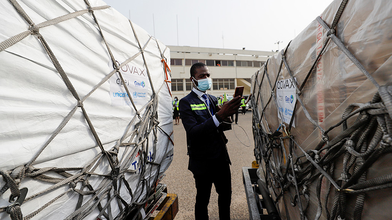 COVAX, the international initiative to vaccinate the globe more equitably, made its first shipment of vaccines on February 24 to Ghana. Here, a worker checks the shipment, which includes 600,000 doses of AstraZeneca/Oxford vaccines. - Photo: Francis Kokoroko/Reuters