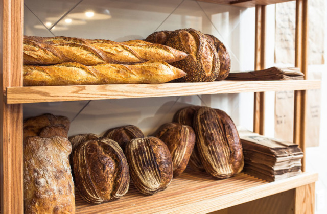Bread loaves and baguettes on the shelves at Allez Bakery in Over-the-Rhine. - Photo: Hailey Bollinger