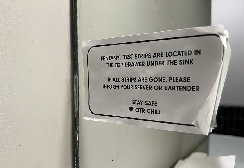 A sign in the bathroom at OTR Chili directing patrons to free fentanyl test strips. - Photo: Madeline Fening