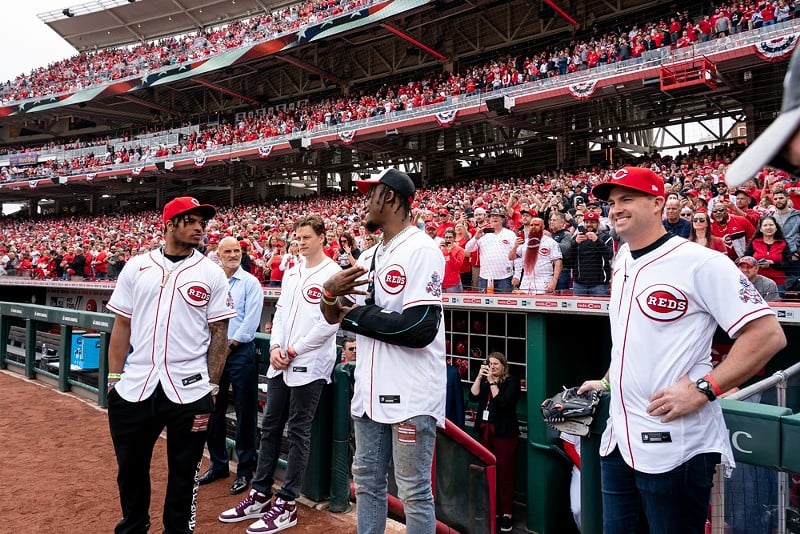 Members of the Cincinnati Bengals crew stand at the dugout before the Cincinnati Reds' home opener on April 12, 2022. - PHOTO: RON VALLE