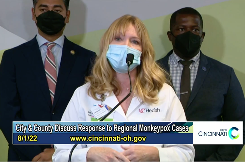 Jennifer Forrester, an infectious diseases specialist at UC Health, addresses the monkeypox outbreak with Cincinnati mayor Aftab Pureval and Cincinnati City Council member Reggie Harris in the background on Aug. 1, 2022. - Photo: facebook.com/cityofcincy