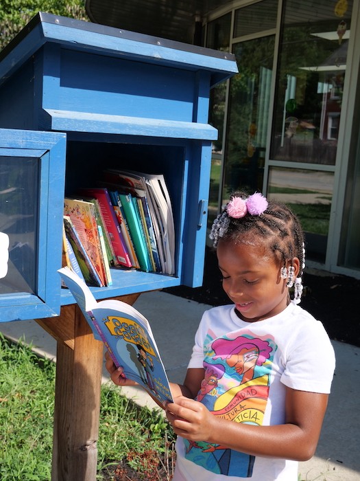 Madison Kelly grabs a book from the library outside McKie Recreation Center. - Photo: Allison Babka