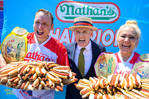 Joey Chestnut (left) winning his 14th Nathan’s Famous Hot Dog Eating Contest by consuming 76 hot dogs within 10 minutes. - Photo: Provided by Hunter PR