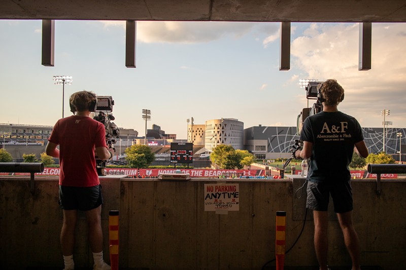 Mason Foley (left) and Nic Dumancic operate cameras one and two from Calhoun Garage at the University of Cincinnati's Gettler Stadium in August. - Photo: Michael Asher