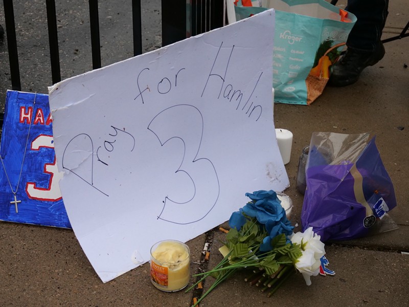 Signs of support for Damar Hamlin line a fence outside UC Medical Center. - Photo: Madeline Fening