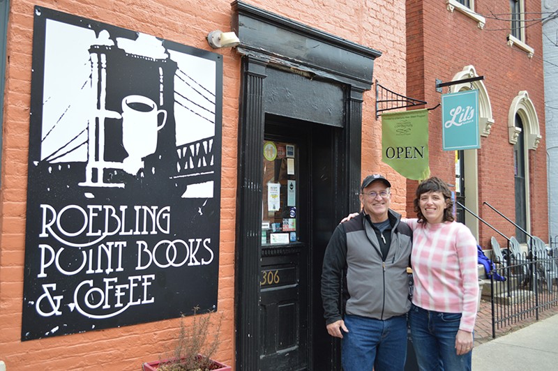 Richard Hunt, owner of Roebling Point Books & Coffee, and Julia Keister, owner of Lil's Bagels, pose in front of Roebling Point Books & Coffee in Covington. - Photo: Katie Griffith