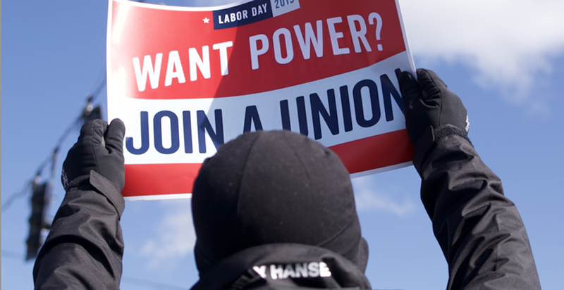 A demonstrator holds a pro-union sign outside KCVG in Hebron, Kentucky on March 18. - Photo: Aidan Mahoney