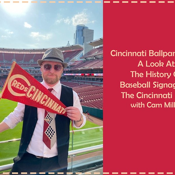 Cam Miller standing at GABP holding a Cincinnati Reds pendant.