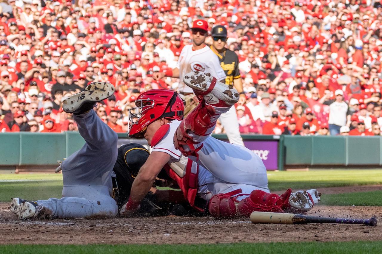 Cincinnati Reds catcher Tyler Stephenson and Pittsburgh Pirates outfielder Bryan Reynolds collide at the plate during the season opener at Great American Ball Park on March 30, 2023.