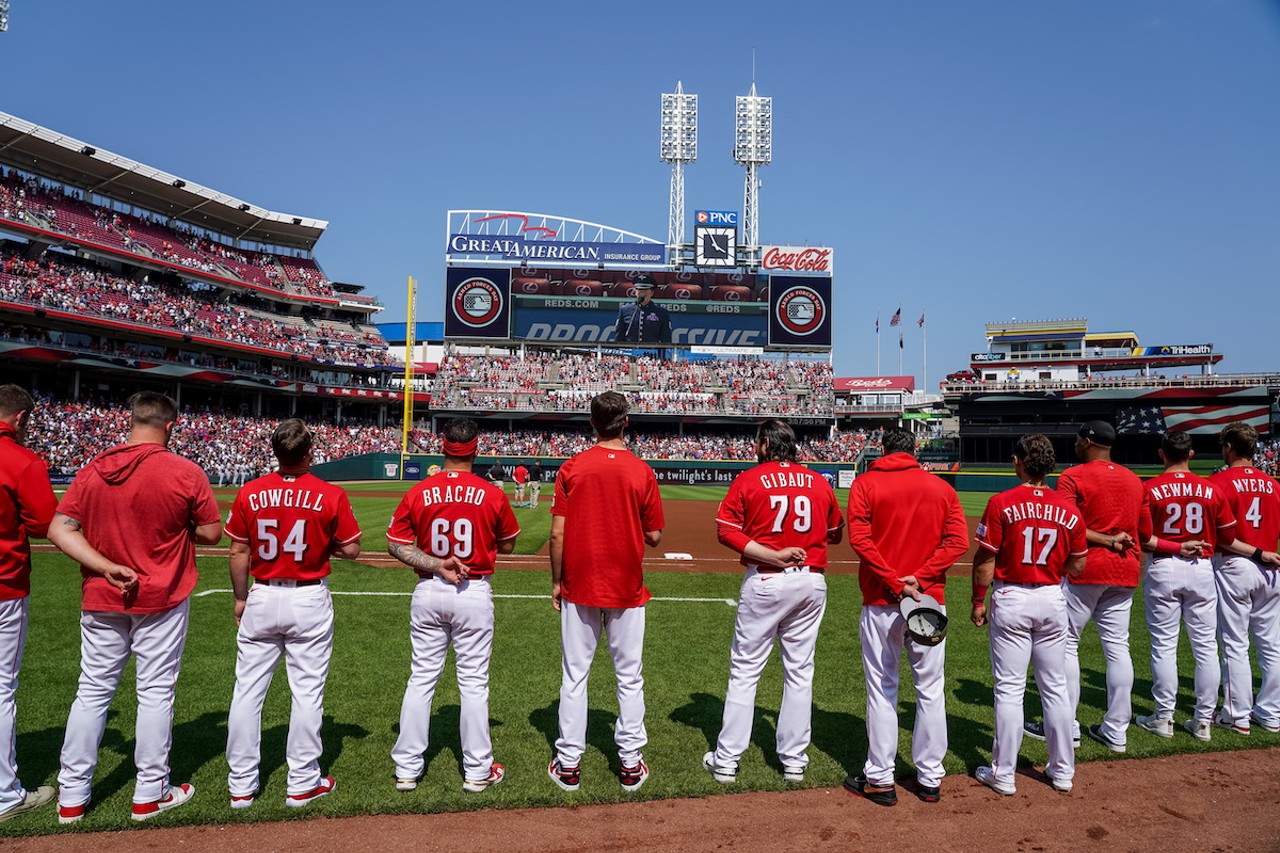 Cincinnati Reds players stand during the National Anthem.