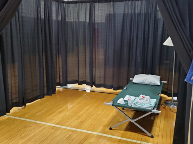 A bed set up in the OTR Community Center for those experiencing homelessness and exhibiting possible COVID-19 symptoms